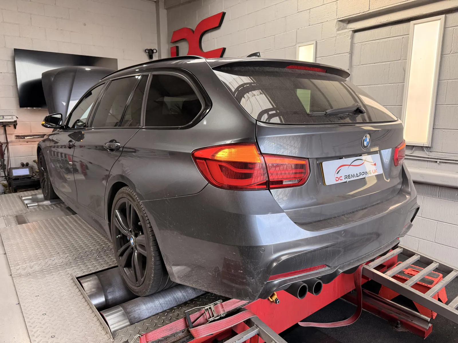 BMW 320i xDrive Touring rear three-quarter on the rollers