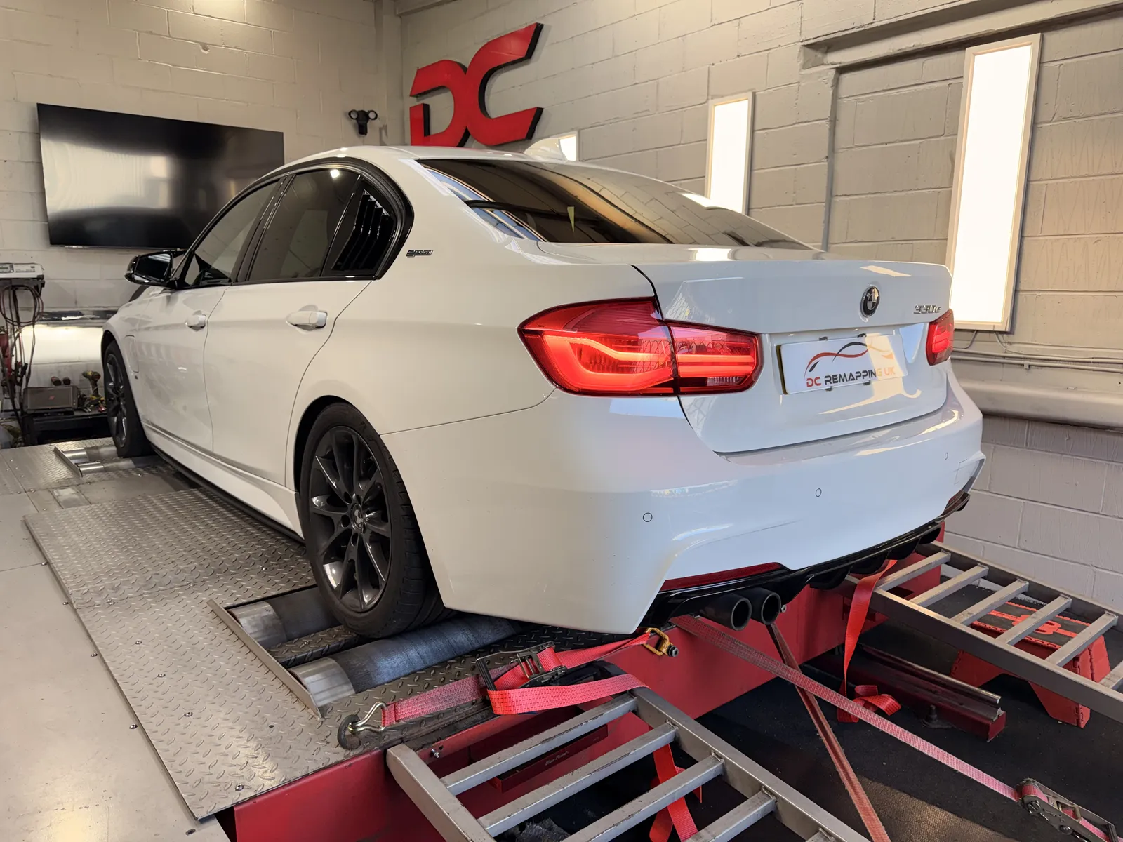 BMW 330e rear three-quarter on the dyno