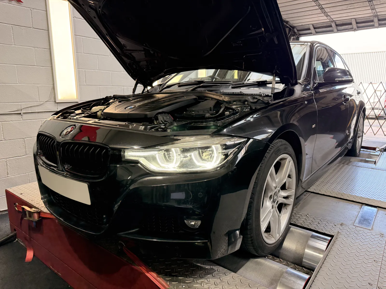 BMW 335d xDrive front three-quarter with the bonnet open