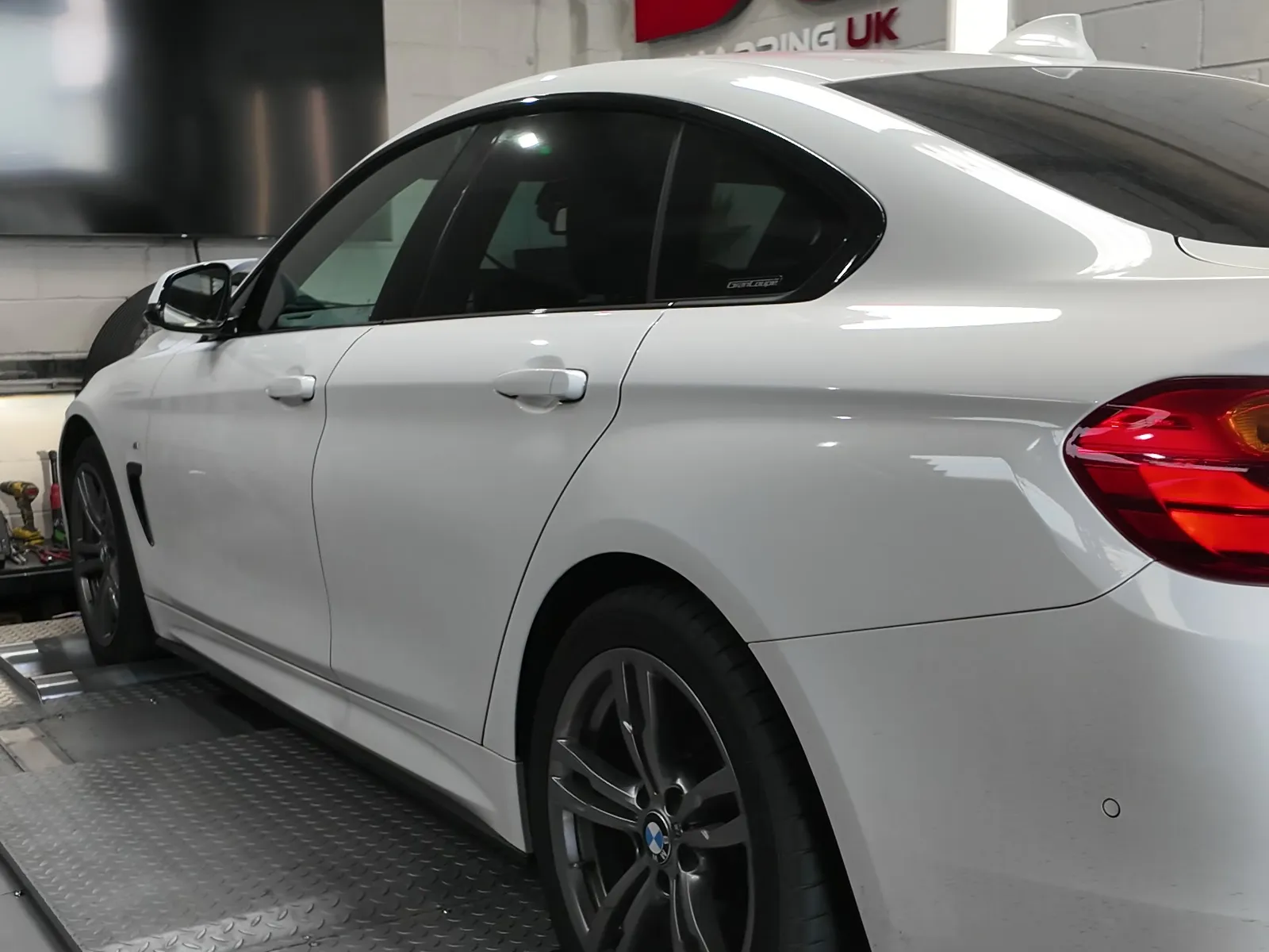 BMW 420i xDrive Gran Coupé rear three-quarter on the rollers