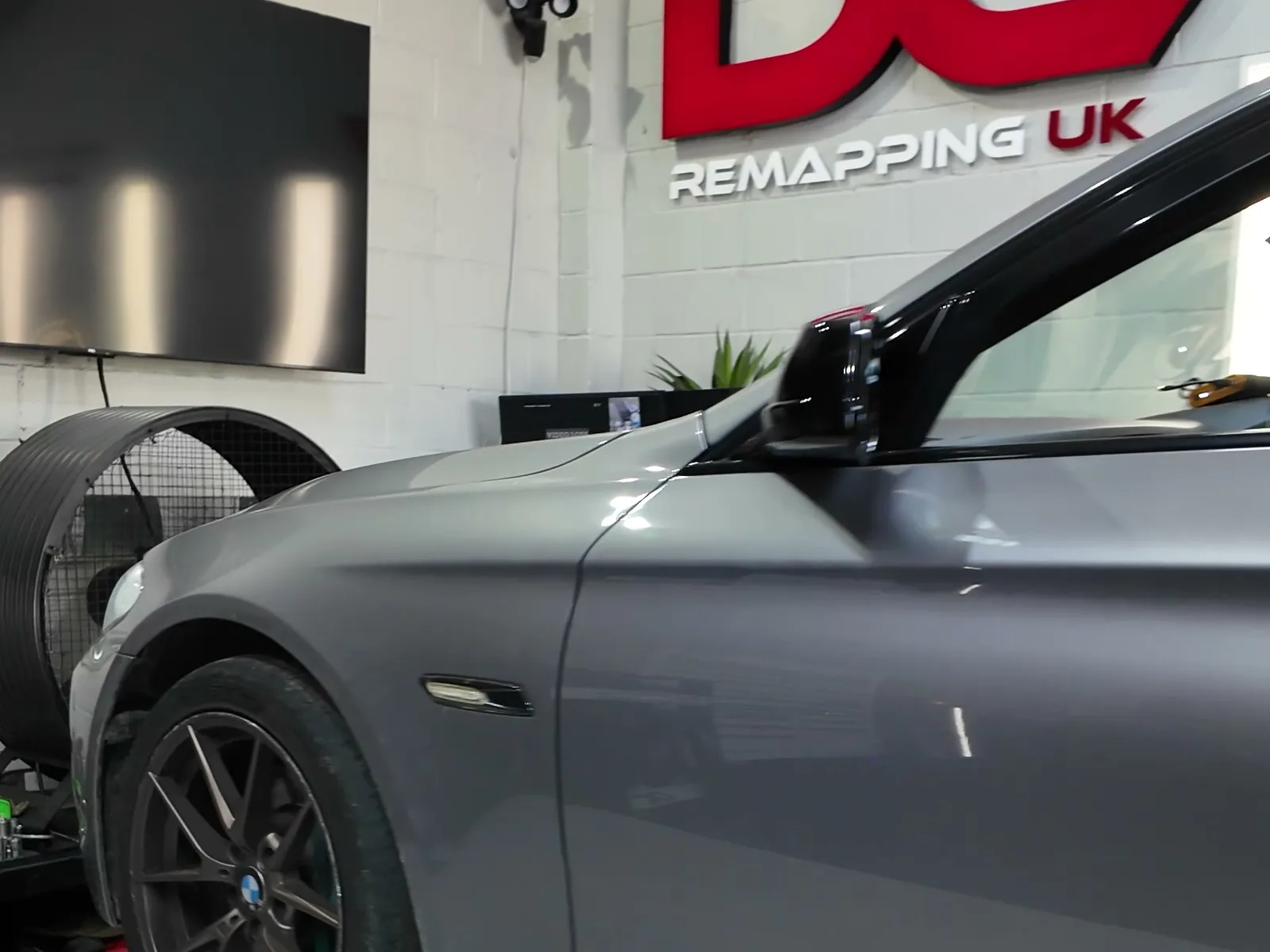 BMW 530d side on the rollers under the DC sign