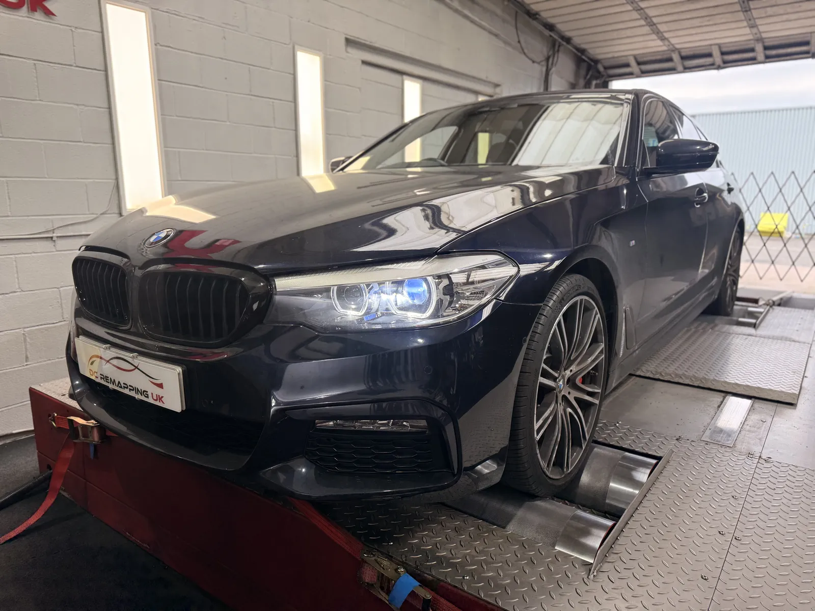 BMW 540i xDrive front three-quarter on the dyno