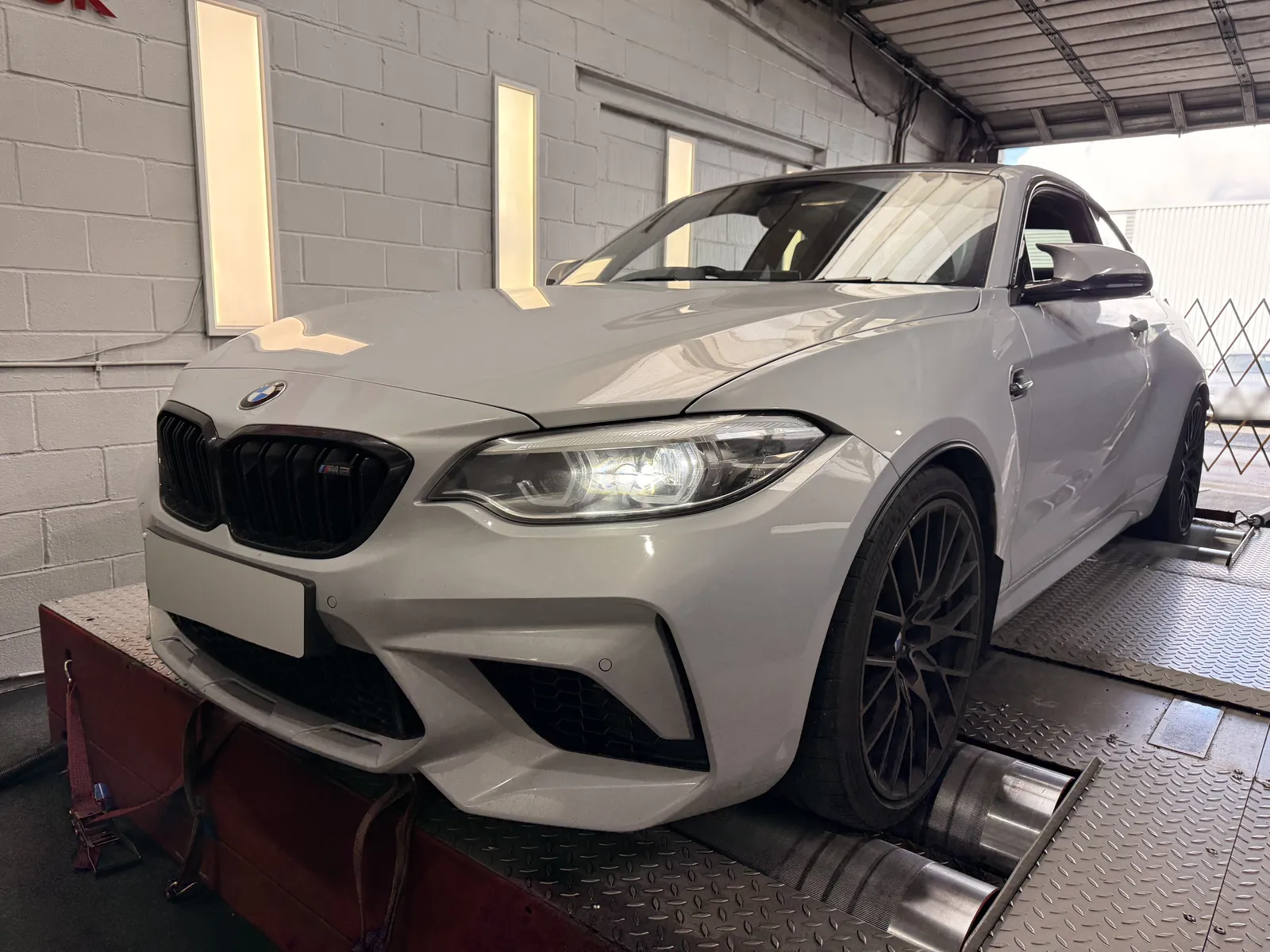 BMW M2 Competition front three-quarter on the dyno