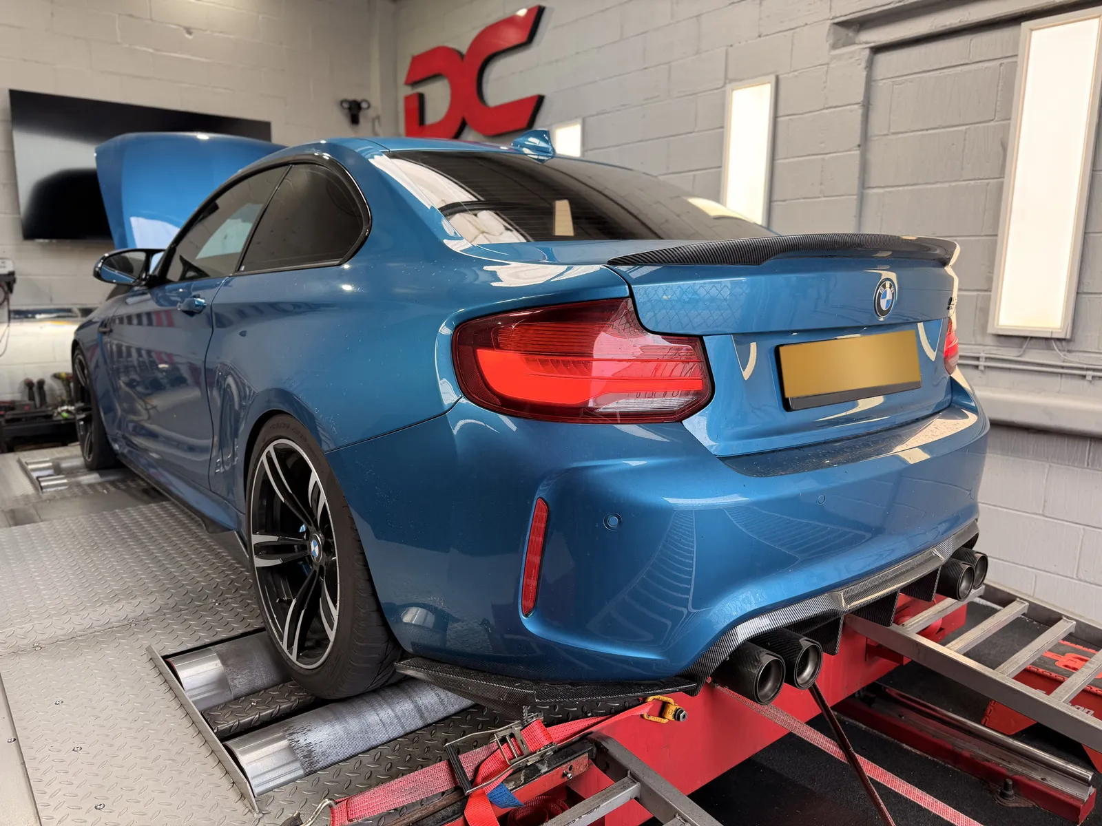 BMW M2 Competition rear three-quarter on the dyno