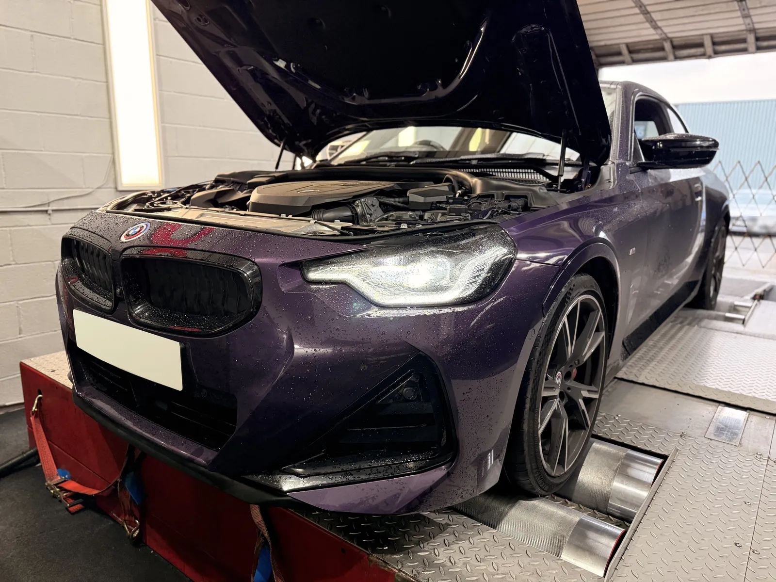 BMW M240i xDrive front three-quarter with the bonnet up