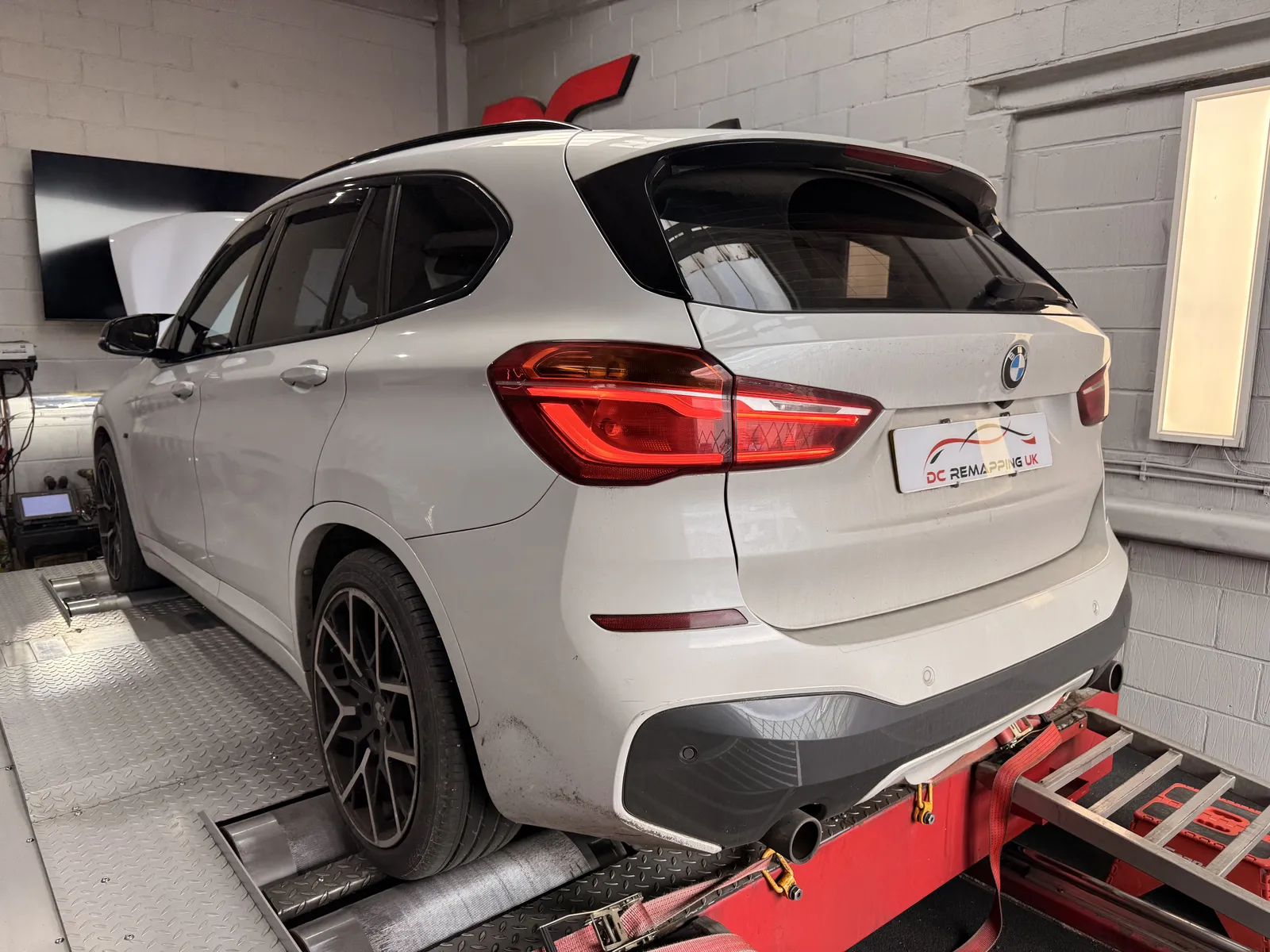 BMW X1 xDrive25d rear three-quarter on the dyno