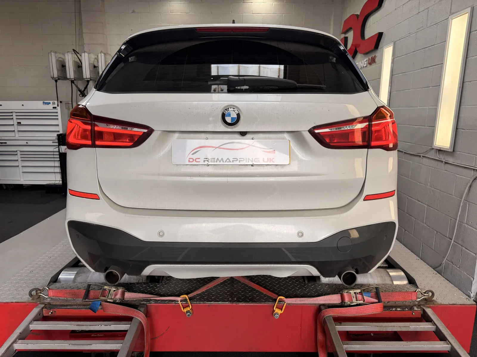 BMW X1 xDrive25d rear view strapped to the rollers