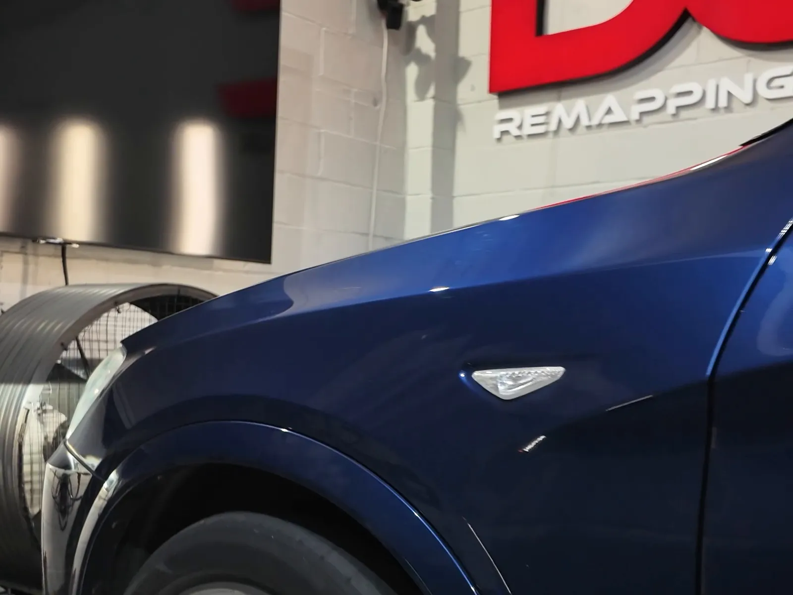 BMW X3 xDrive30d side on the dyno under the DC sign